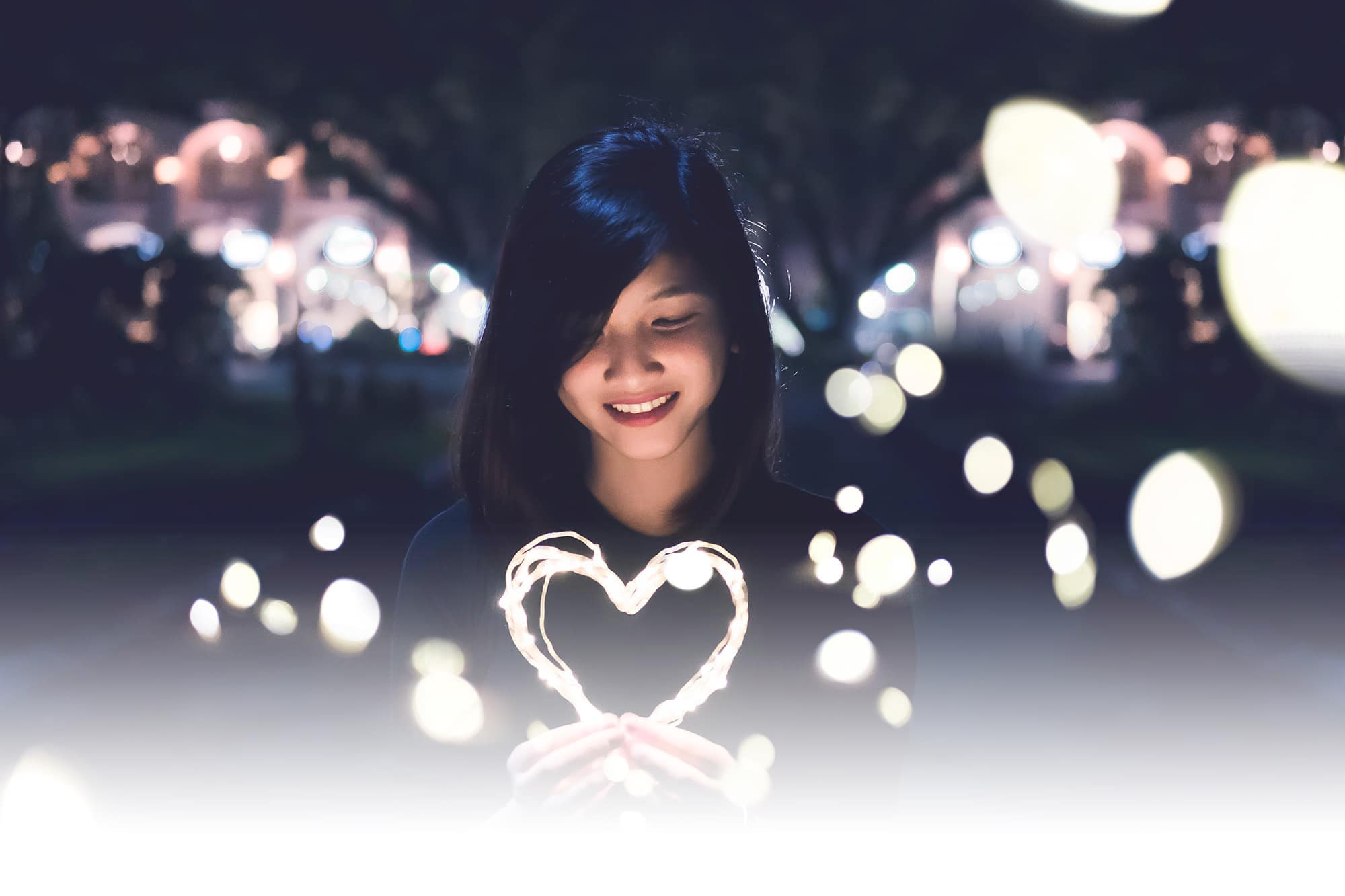 Woman smiling holding a heart