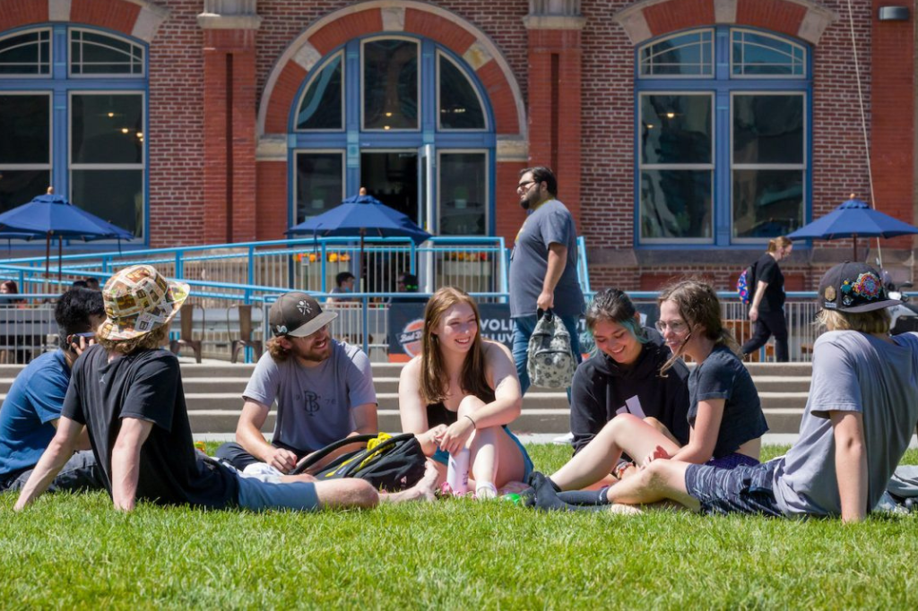 student sitting on lawn