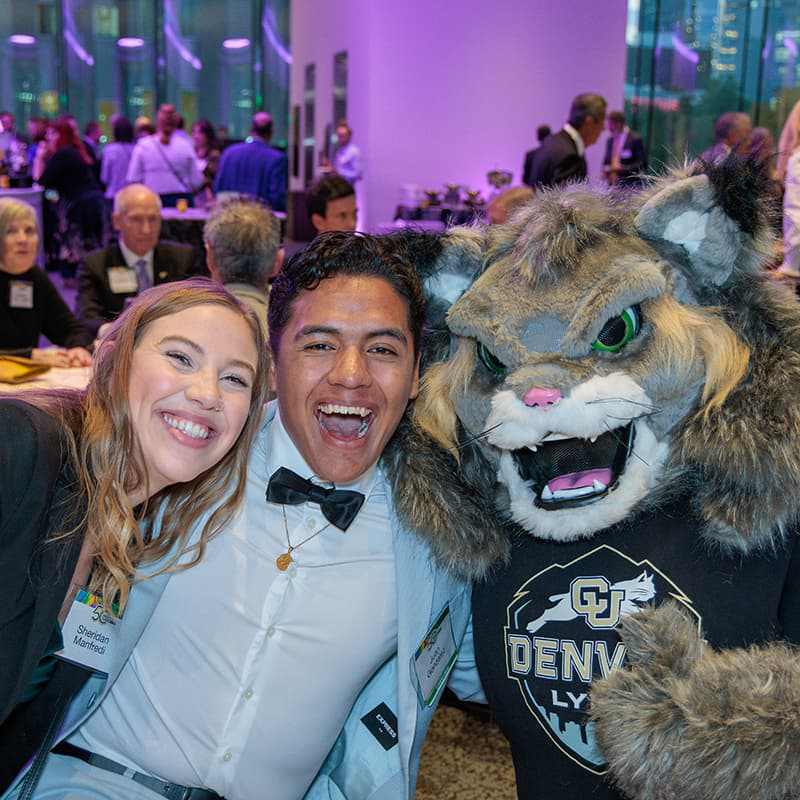 Two CU Denver students smiling with Milo.