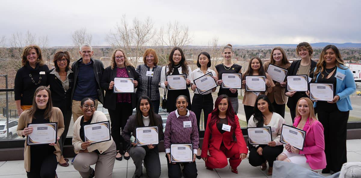 Group of Empowering Women in Business Program Participants holding certificates and smiling.