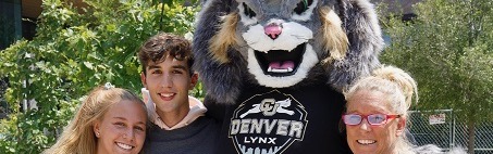 Outdoors image of a CU Denver student with their family and Milo