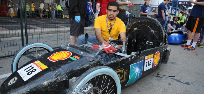 student working on race car