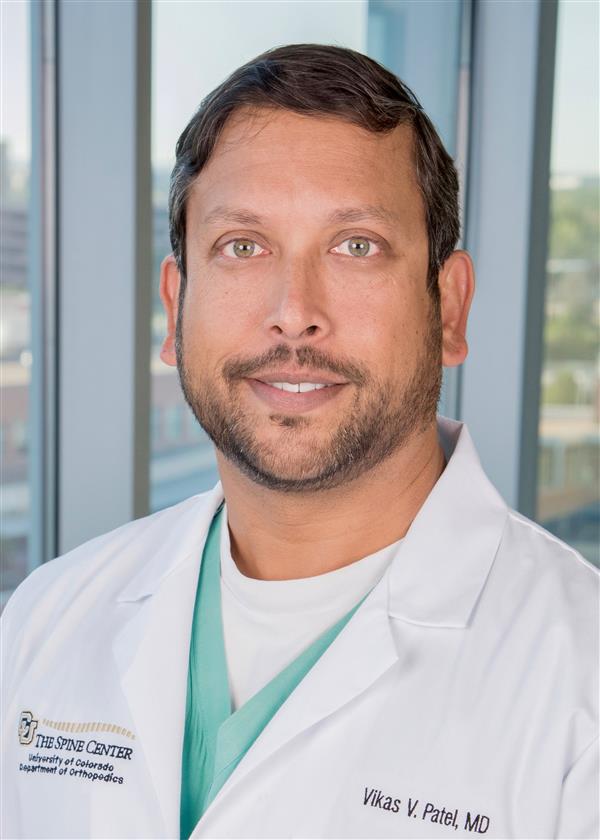 headshot of Vikas Patel from the chest up in medical attire