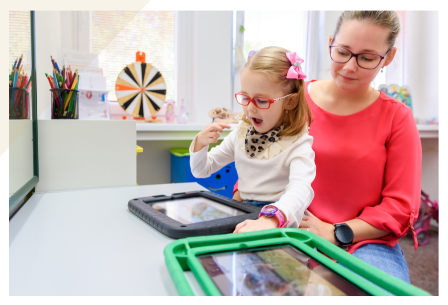 A student using an iPad and a teacher